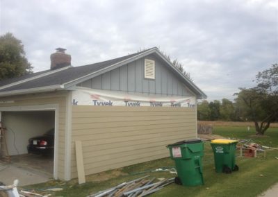 Image representing Gorilla Exteriors vinyl siding repair and installation services in Kansas City showcasing new siding work being done on the garage of a ranch home.