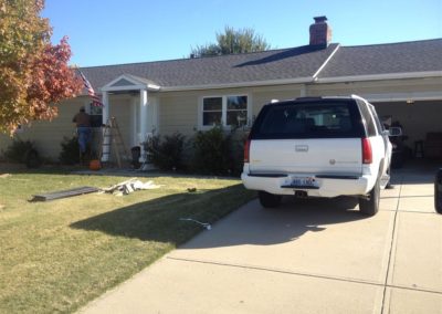 Image representing Gorilla Exteriors vinyl siding repair and installation services in Kansas City showcasing new siding work being done on the front of a ranch home.