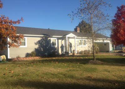 Image representing Gorilla Exteriors vinyl siding repair and installation services in Kansas City showcasing new siding on a home with a man standing on the porch.