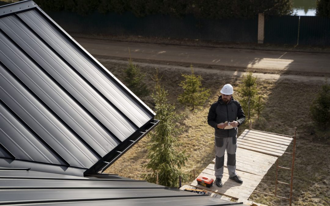 man on roof doing exterior check of roof siding windows and gutters