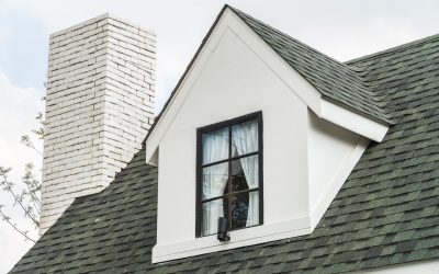 Charming house gable with shingle roof and chimney, emphasizing roofing quality and home improvement for Kansas City homeowners.