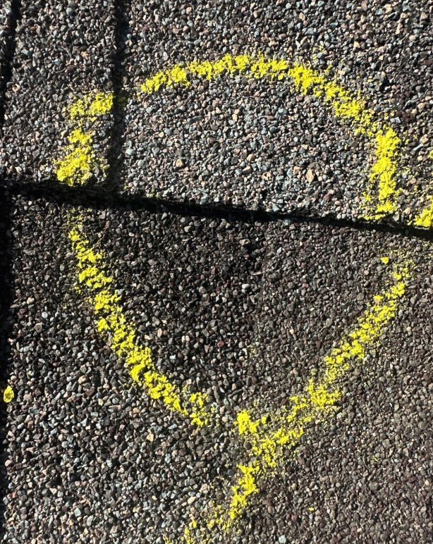 Hail Damage Roof Inspection 3 Yellow chalk markings on asphalt shingles indicating areas of potential hail damage for roofing inspection.