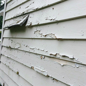 How Spring Storms Destroy Kansas City Siding and Exterior Paint 2 Damaged exterior paint on residential siding, showing peeling and cracking from hail impact and moisture exposure.